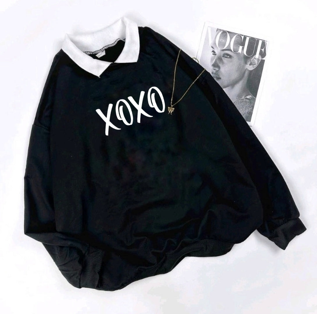 Black baby romper with 'XOXO' text on a white background