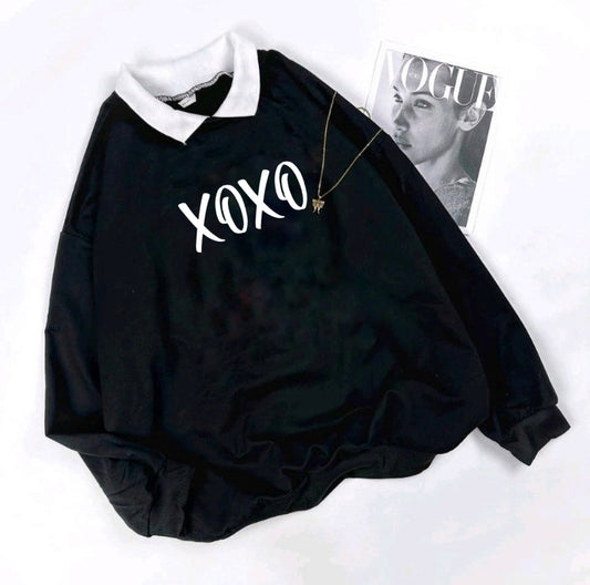 Black baby romper with 'XOXO' text on a white background