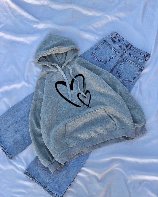 Light blue hoodie with heart design and jeans on a light blue background